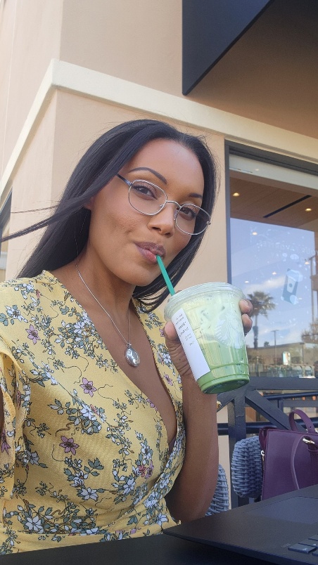 beautiful black woman drinking a matcha tea outside of starbucks on bastanchery